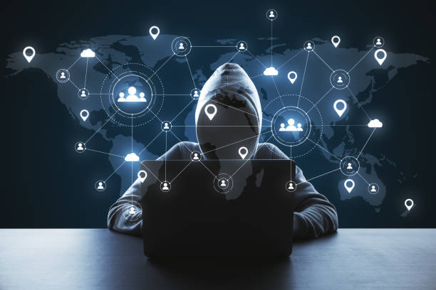 istock Hacker using laptop with social media network and remote work hologram. 1245293303