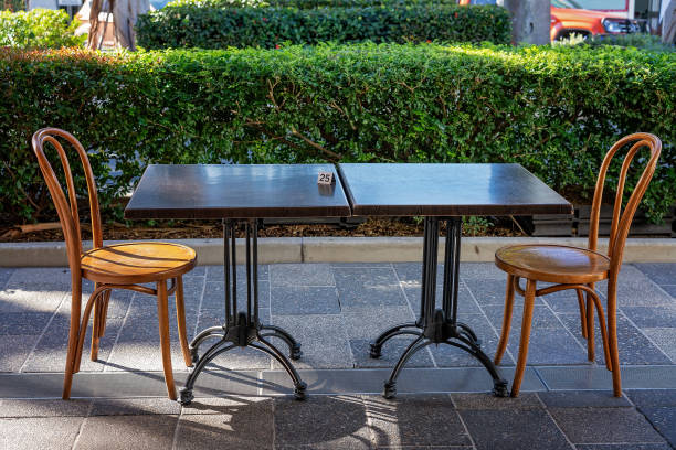 A table and chairs set up for two people under social distancing rules during the pandemic at a sidewalk cafe