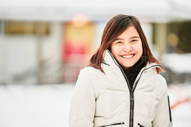 istock Cheerful young girl in winter jacket 1245301388