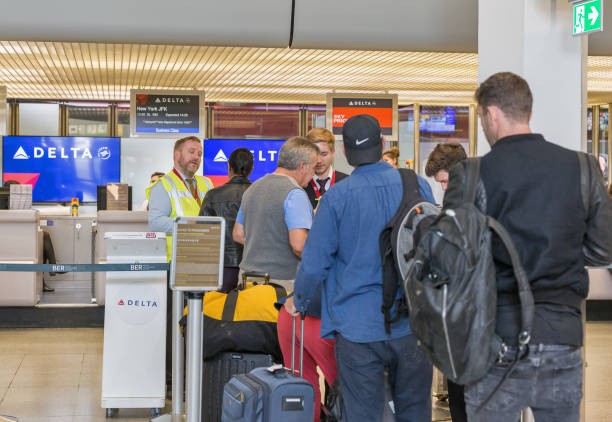 delta air lines desk in tegel airport. berlin, germany. - airport airport check in counter arrival departure board checkout counter imagens e fotografias de stock