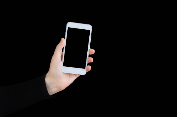 istock White smartphone in hand close-up on a black background. 1245321352