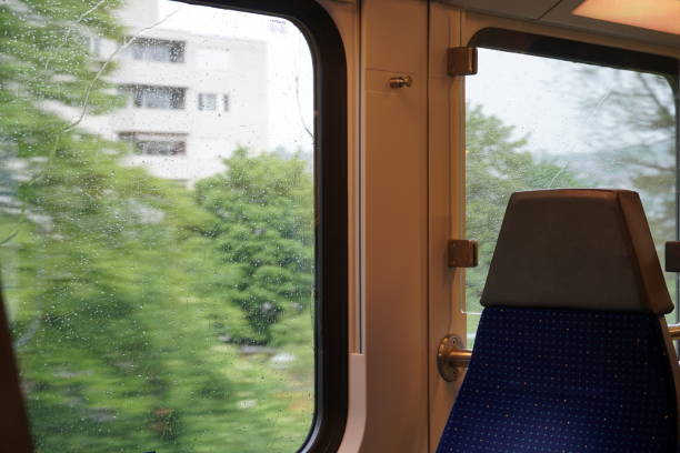 istock Empty commuter train on a rainy day, the windows are covered by raindrops., the trees and buildings flash by in the movement of the train. 1245324341