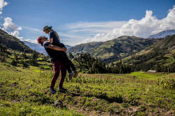couple in a peak of mountain, blue sky, clouds and sunny day couple in a peak of mountain, blue sky, clouds and sunny day peru travel stock pictures, royalty-free photos & images