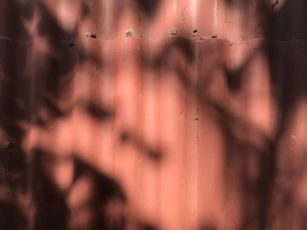 istock background texture fence of red slate with hard shadows from tree branches 1245342837