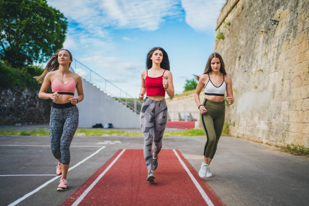 istock Sporty women running together 1245359645