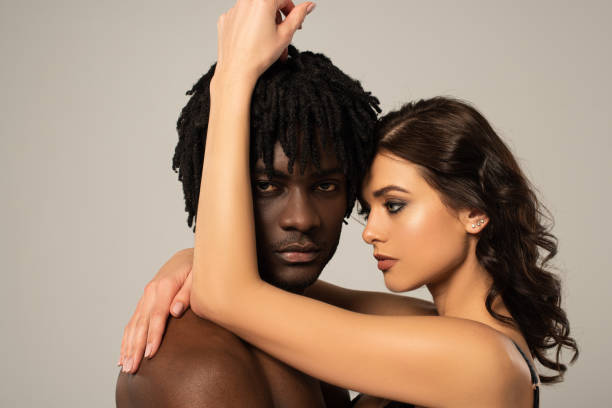 istock passionate multiethnic couple hugging isolated on grey 1245377391