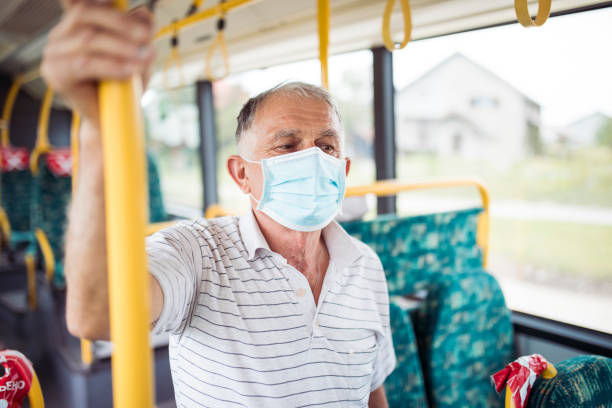 Worried Senior Man With Protective Face Mask In Bus Transport