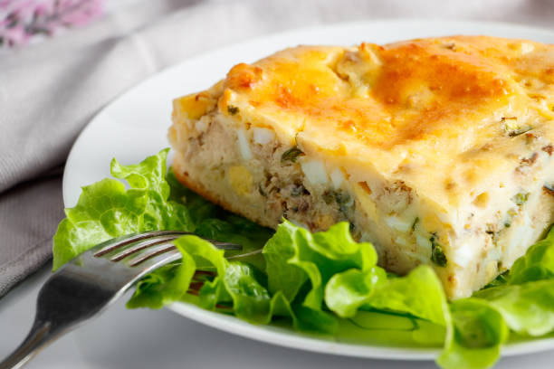 istock Homemade fish pie with greens on a plate. Mediterranean dish on a white background. 1245377652