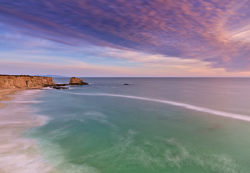 Panorama of dramatic storm cell with rain at sunset over the open ocean. Photographed on the east coast of Australia.