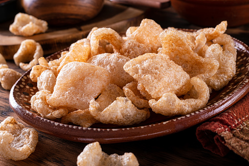 A plate of delicious deep fried pork rind chicharrones.