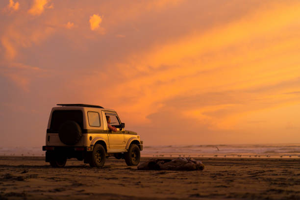 Orange sky illuminates Pacific Ocean in distance