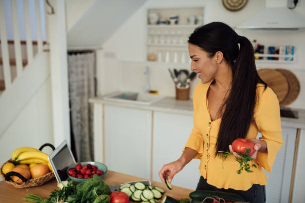 istock Cheerful young woman preparing food and vlogging 1245410062