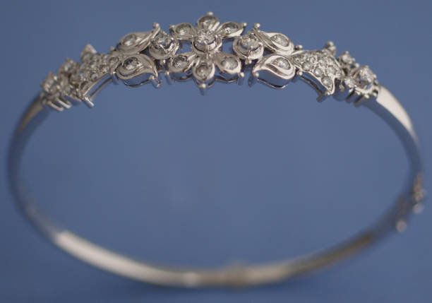 White Gold bangle bracelet studded with diamonds. Hinged bracelet with clip