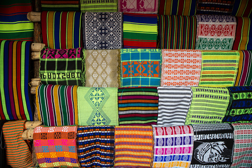This is an abstract close up photograph of several colorful traditional Mexican blankets for sale in Playa Del Carmen, Mexico