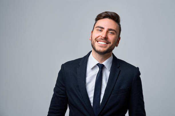 fermez le portrait jeune homme d’affaires. homme caucasien costume d’affaires studio fond gris. - suit necktie close up gray photos et images de collection