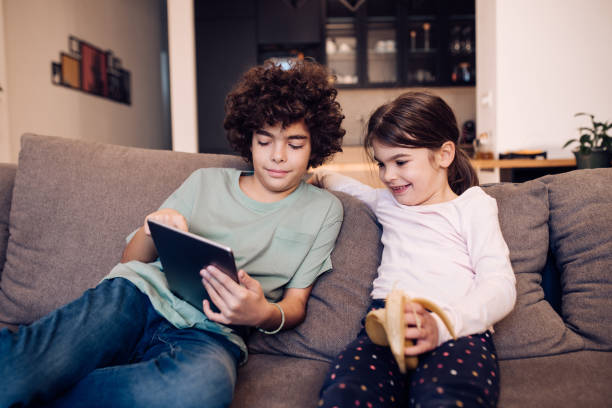istock Kids spending weekend evening watching movies on tablet 1245463283