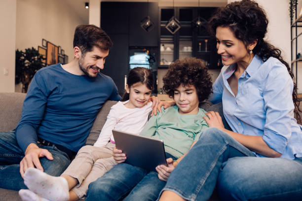istock Happy family enjoying together with digital tablet 1245463793
