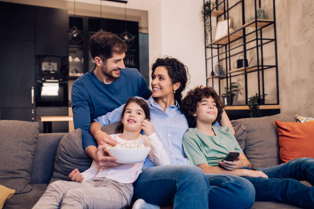 istock Family enjoying on the sofa, watching TV 1245463800