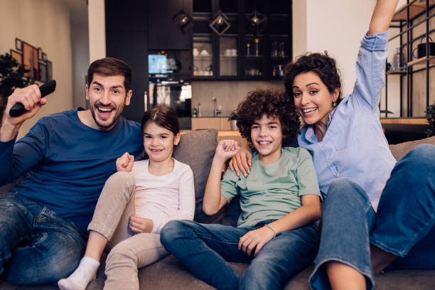 istock Excited family watching TV and cheering 1245463807