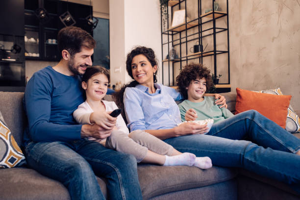 istock Family enjoying watching TV at home 1245463809