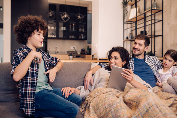 istock Happy family enjoying together on the sofa 1245463828