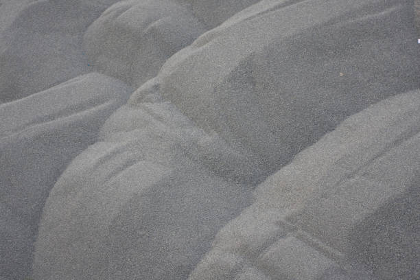 istock 9 June 2008 Zen garden stone on black sand with pattern. 1245464980