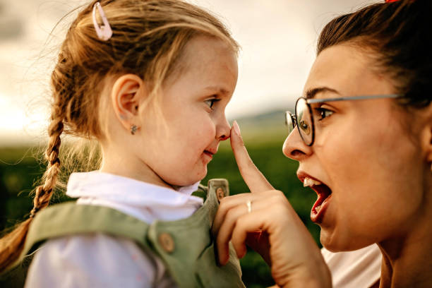 istock Mother having fun with daughter in strawberry field 1245473338