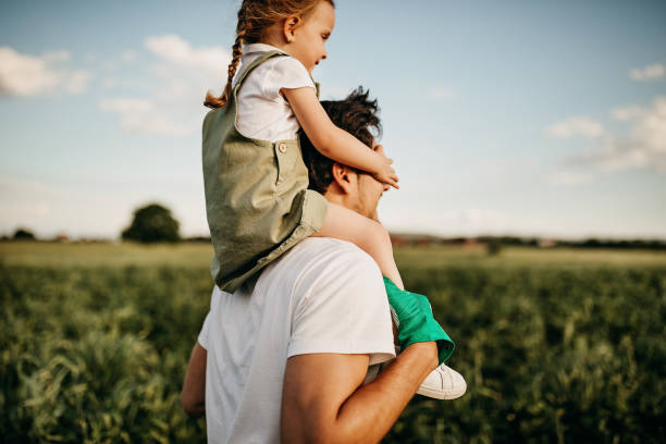 istock Father playing with daughter in filed 1245473468
