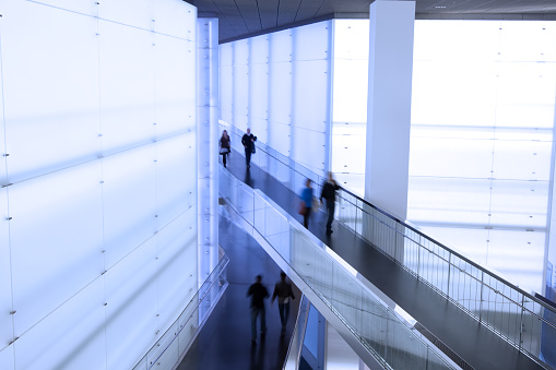 group of people in a modern office building, motion blurredBusinessman walking in a modern office building, blurred in motion