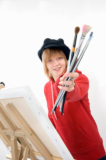istock Young female student artist with easel 124550030