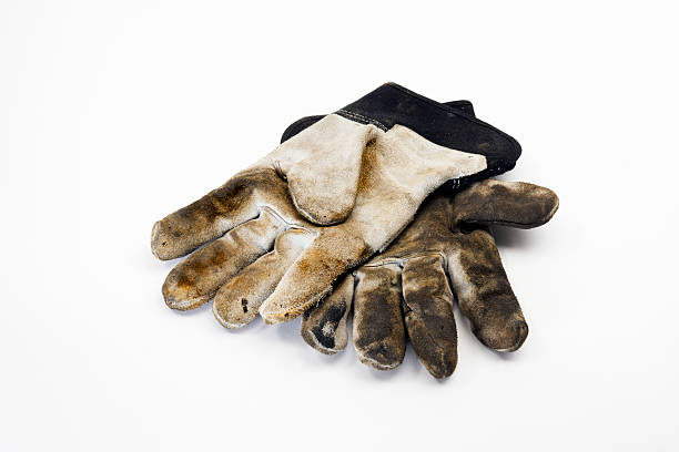 istock Dirty well-used work gloves on white 124550054