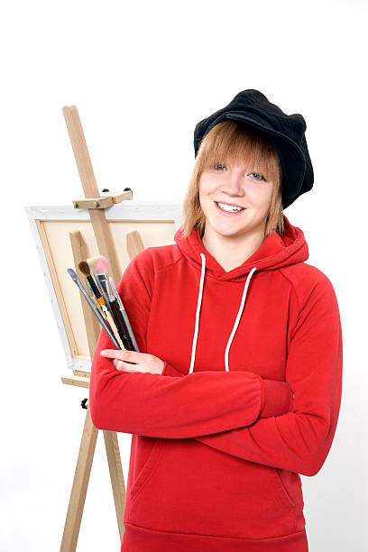 istock Happy art student with brushes and easel 124550081