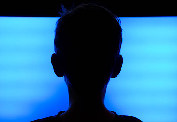 Flat Screen TV Boy Boy (9 years) looking at the typical blue screen of a flat screen television. broken flat screen stock pictures, royalty-free photos & images