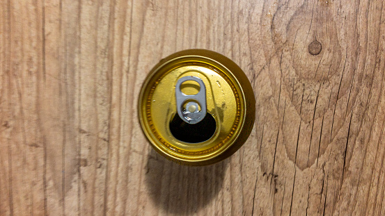 Can of cold beer on wooden table. Top view