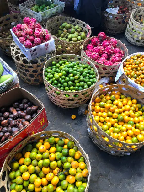 Photo of Colorful, tree ripened fruit and flowers in an open-air farmer's market in Bali, Indonesia, Southeast Asia