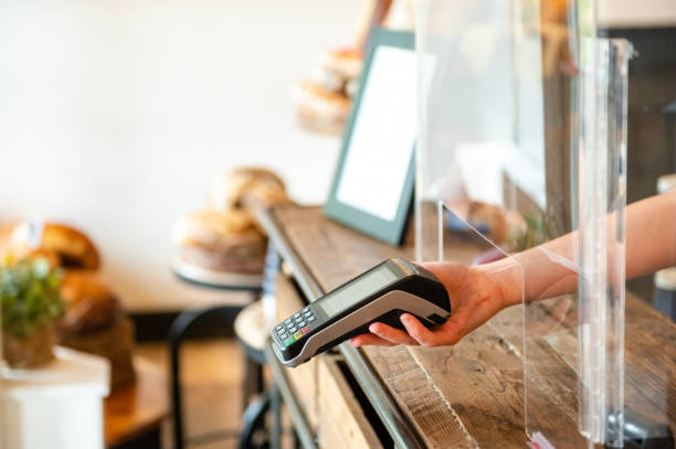 istock Contactless payment terminal with a sneeze guard for COVID-19 1245544604