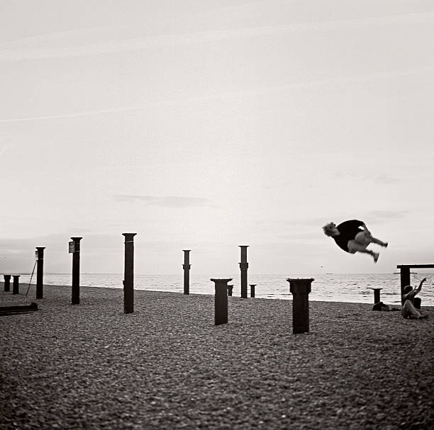 istock Kid plays jumping at dusk on the beach 124562709
