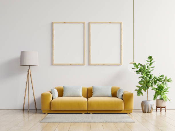 istock Poster mockup with vertical frame standing on floor in living room interior with yellow sofa. 1245636039