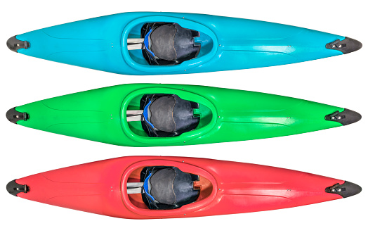 Two kayaks - red and green ones are on the green grass