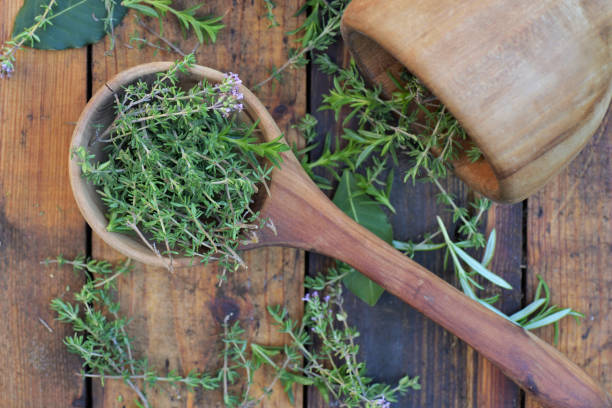 istock aromatic herb in a woden spoon and mortar on a wooden table 1245659697