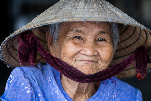 Nha Trang, Vietnam - march 30, 2020 : Ethnic old woman with smile on the face on a street market of Nha Trang, Vietnam