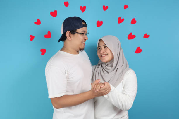 Portrait of happy Asian muslim couple smiling, husband and wife hugging full of love, family concept