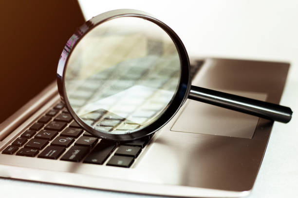 istock Laptop computer with magnifying glass, concept of search. 1245676504