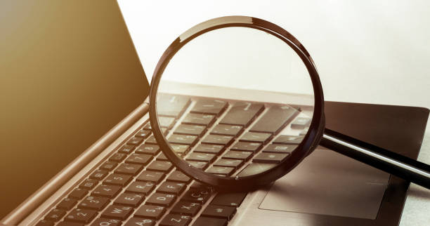 istock Laptop computer with magnifying glass, concept of search. 1245676510