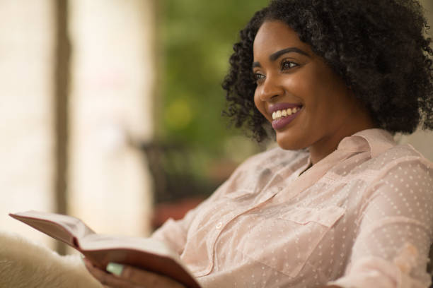 istock Woman smiling holding a book. 1245694932