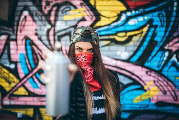 Photo of Graffiti artist with spray paint