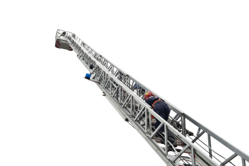 Fireman climbing up the ladder isolated over white