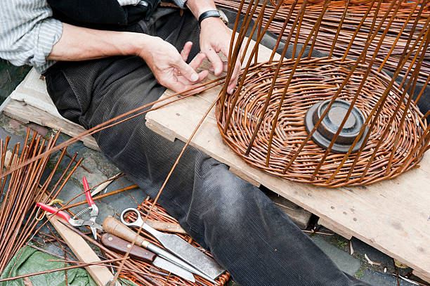 Making a wicker basket Man's hands producing a wicker basket basket weaving stock pictures, royalty-free photos & images