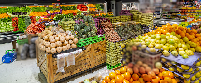 Greengrocery full of fruits and vegetables in an empty space without people