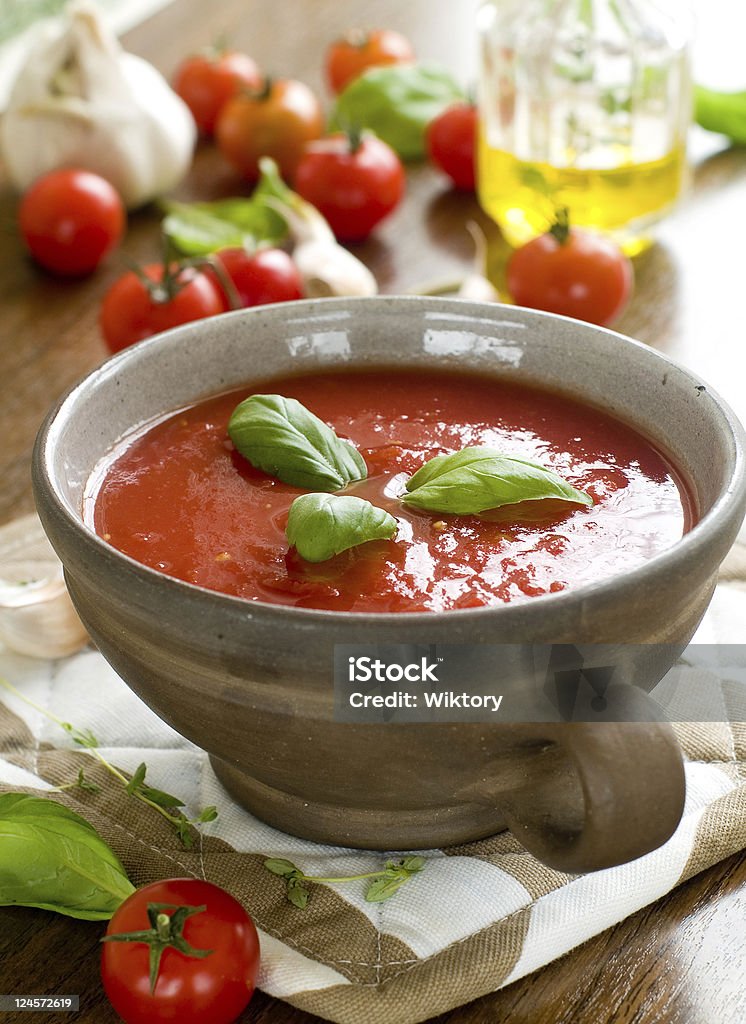 Tomato soup A bowl of  fresh gazpacho (cold tomato soup). Basil Stock Photo